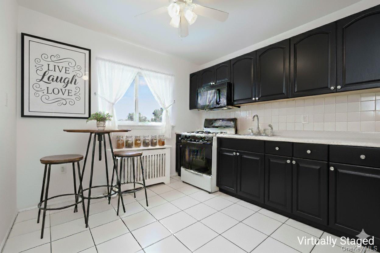 73-21 220th Street, Unit 139B2 Queens, NY 11364 - Photo 8 of 35 a kitchen with stainless steel appliances a cabinets and a sink