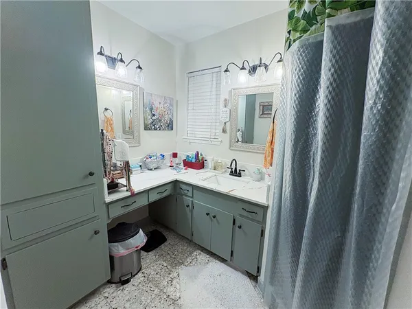 a bathroom with a sink vanity and mirror