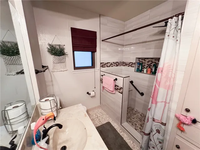 a bathroom with a sink toilet and shower