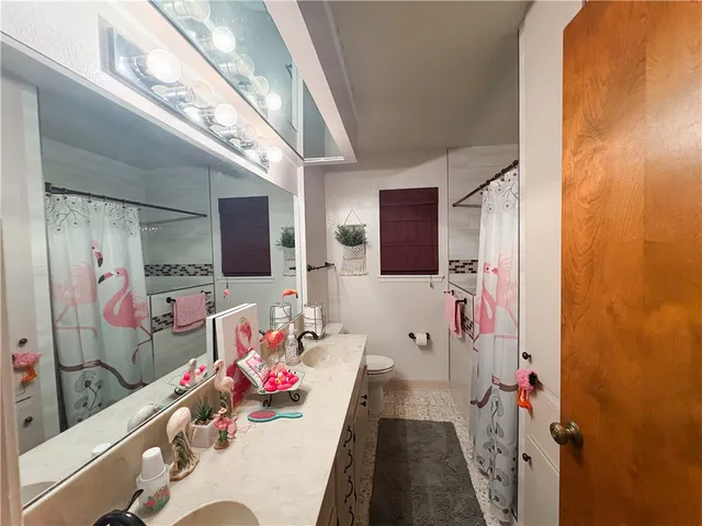 a bathroom with a sink mirror and shower