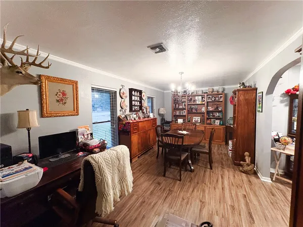 a view of a workspace with furniture and wooden floor