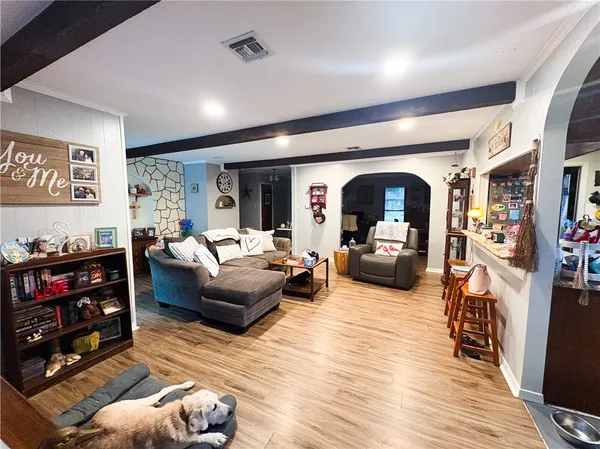 a living room with furniture and a flat screen tv