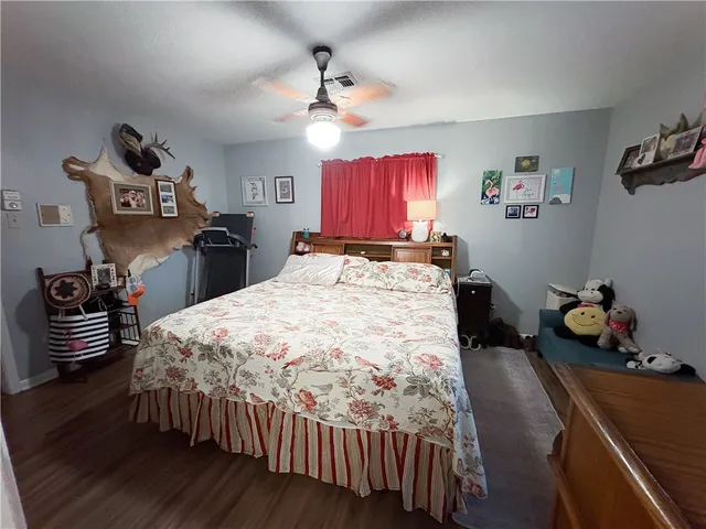 a bed room with a bed and a chair