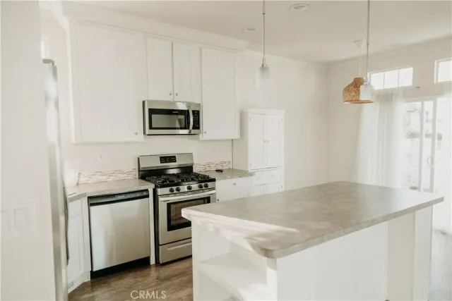 a kitchen with granite countertop a stove and a sink