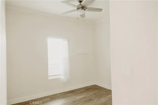 a view of a small space with wooden floor and a window