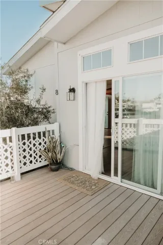 a view of a balcony with wooden floor