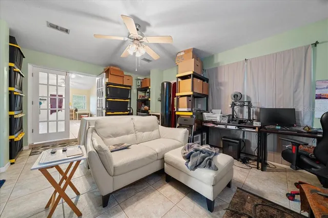 a living room with furniture workspace and a window
