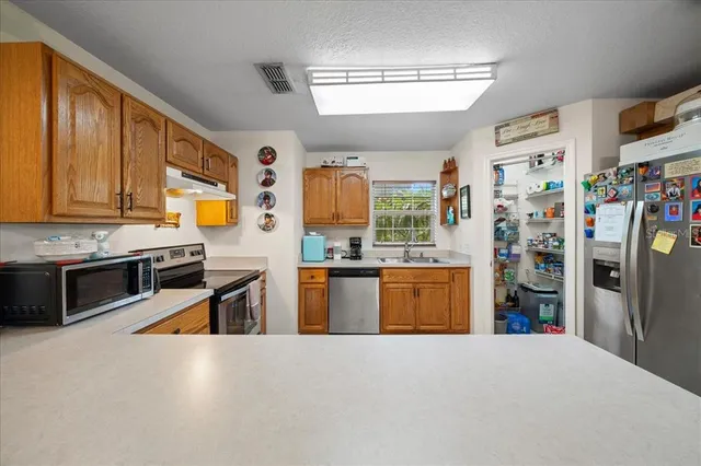 a view of a swimming pool with a patio and a yard