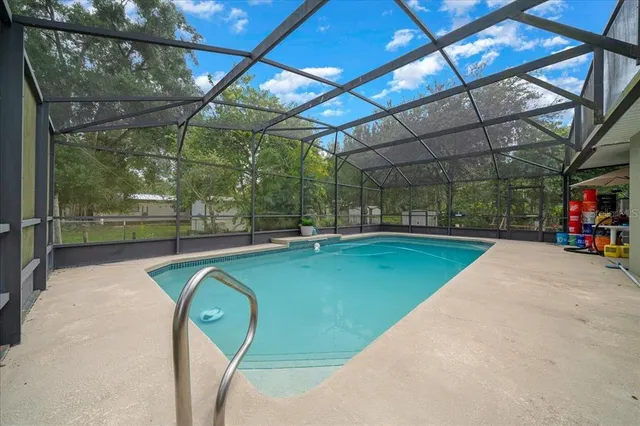 a large kitchen with granite countertop a large counter top stainless steel appliances and cabinets
