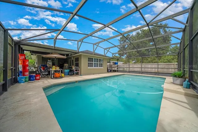 a view of a backyard with a swimming pool