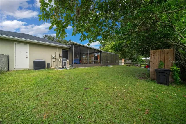 a backyard of a house with plants and tree