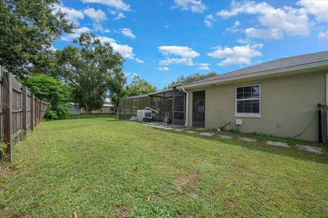 a view of a house with backyard and sitting area