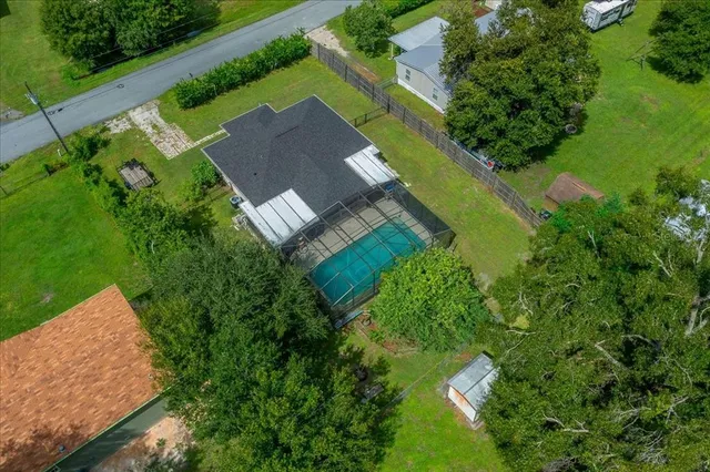 an aerial view of a house with a yard