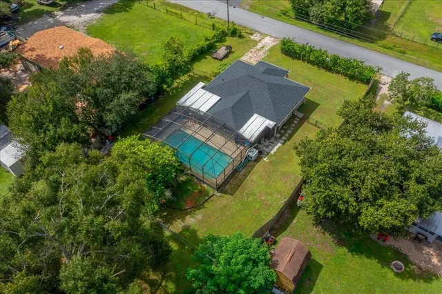 an aerial view of residential houses with outdoor space and swimming pool