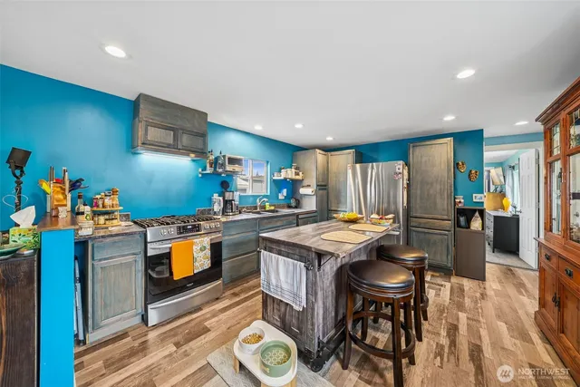 a kitchen that has a table and chairs in it