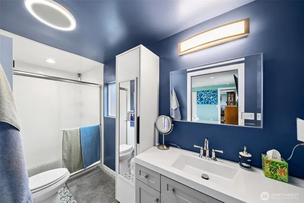 a bathroom with a sink toilet and shower