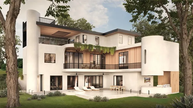 a front view of a residential apartment building with a yard table and chairs