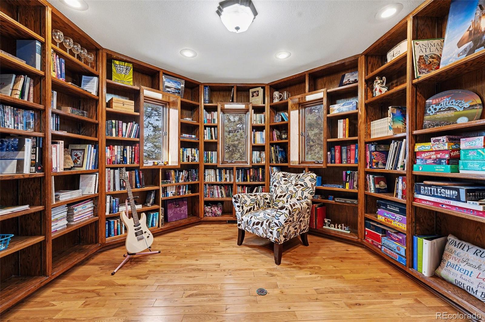 6650 North Village Road Parker, CO 80134 - Photo 13 of 46 a view of living room filled with furniture and book shelf
