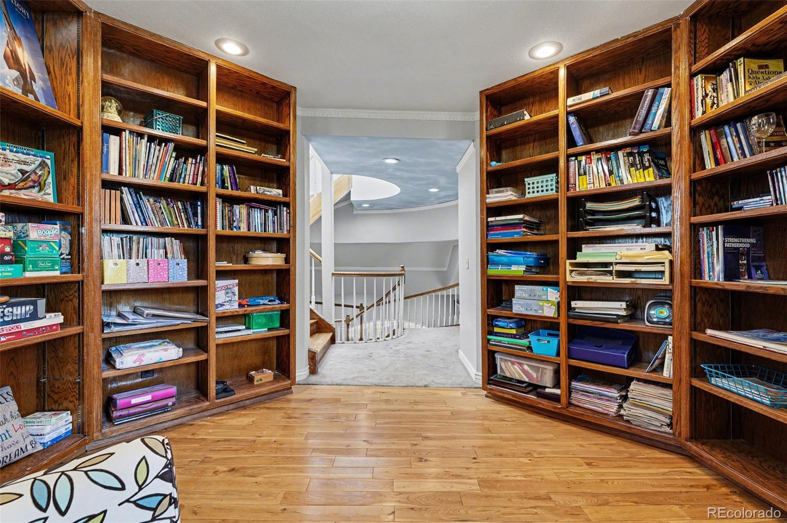 6650 North Village Road Parker, CO 80134 - Photo 14 of 46 a view of room with furniture and book shelf