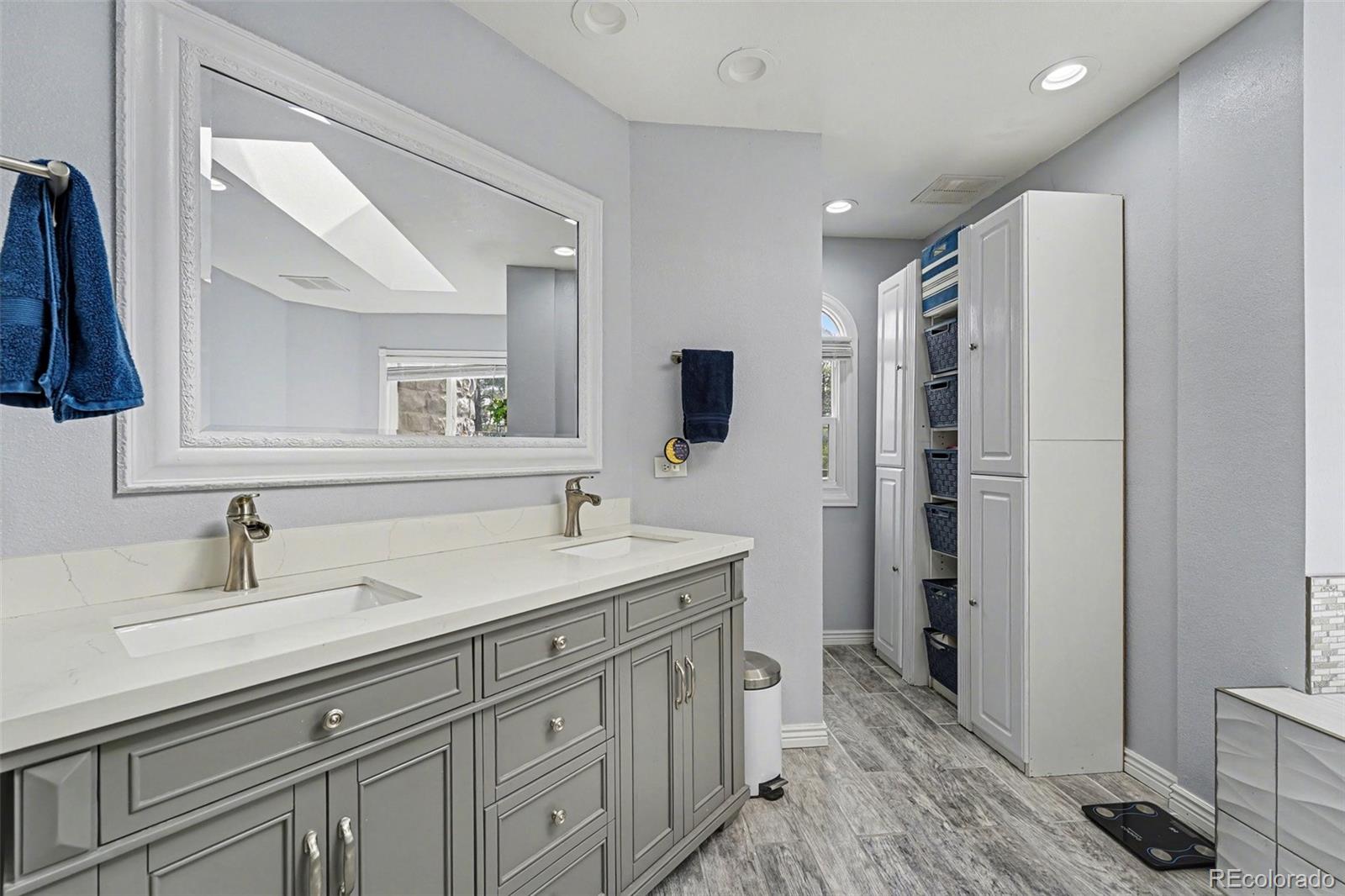 6650 North Village Road Parker, CO 80134 - Photo 20 of 46 a bathroom with a sink double vanity and a mirror