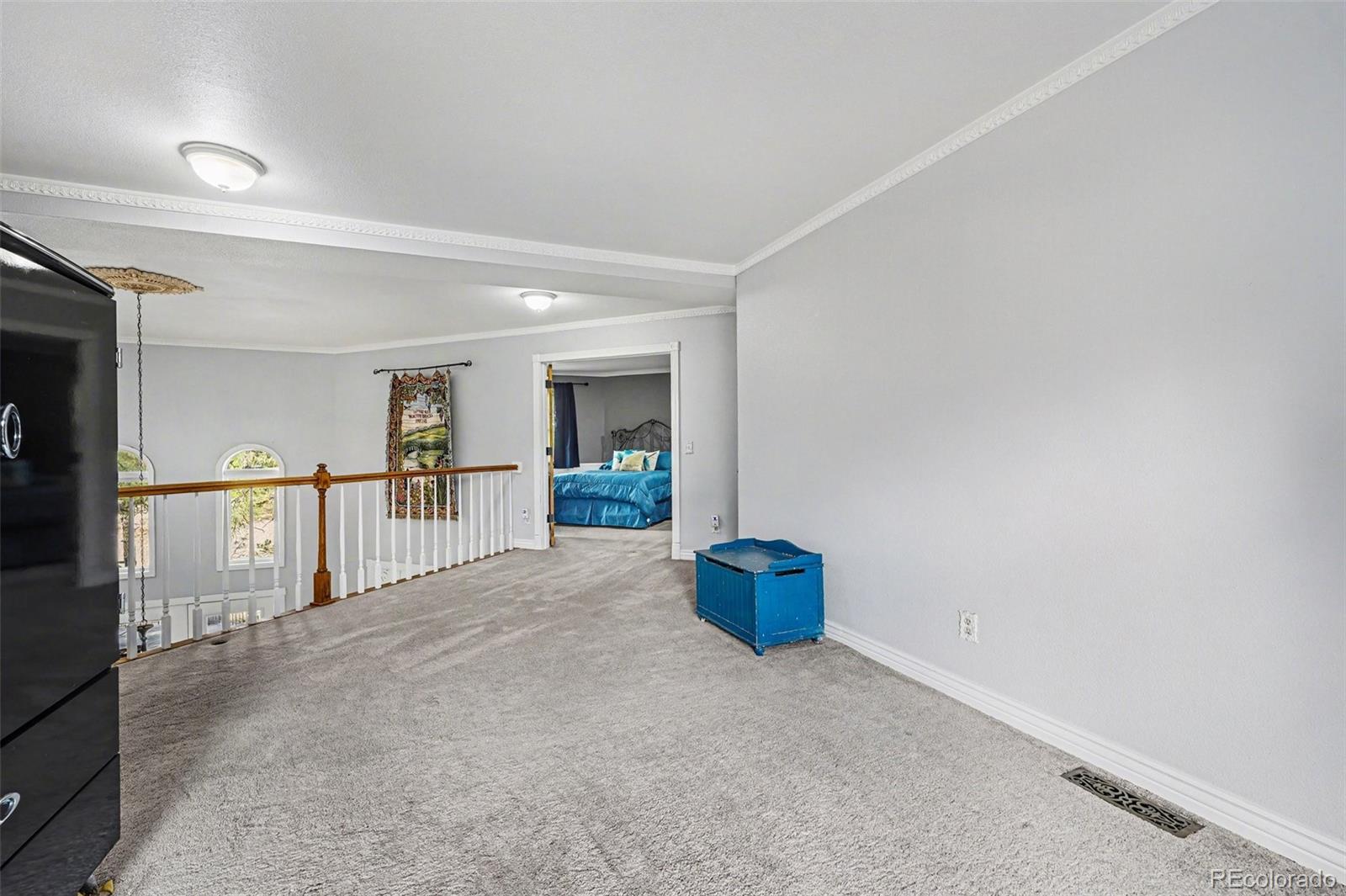 6650 North Village Road Parker, CO 80134 - Photo 26 of 46 a view of empty room with wooden floor and kitchen