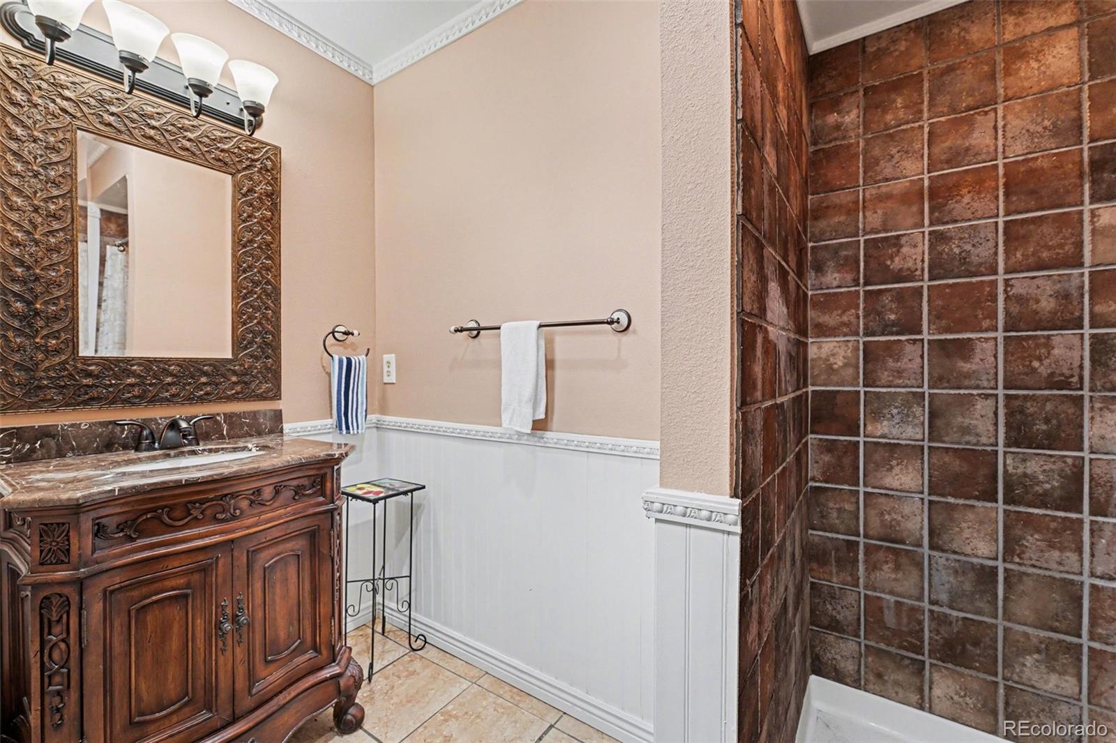 6650 North Village Road Parker, CO 80134 - Photo 29 of 46 a view of a bathroom with a sink and a mirror