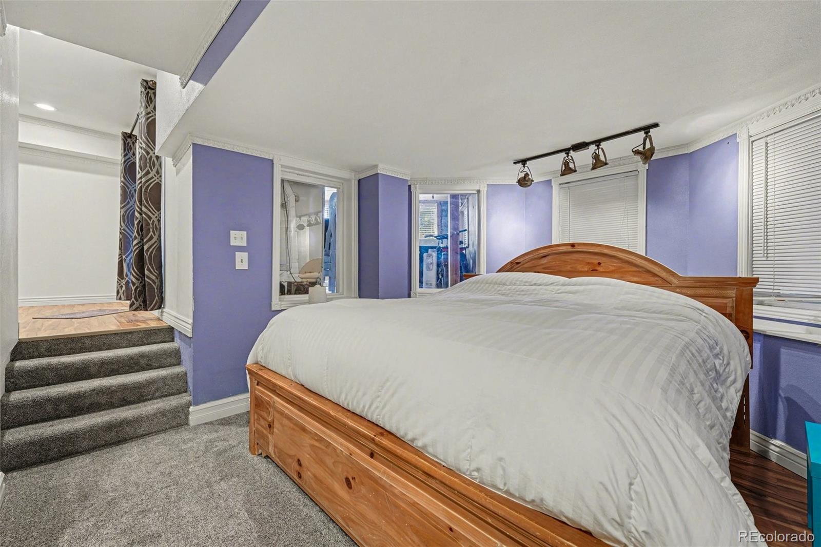 6650 North Village Road Parker, CO 80134 - Photo 30 of 46 a bed sitting in a bedroom next to a window