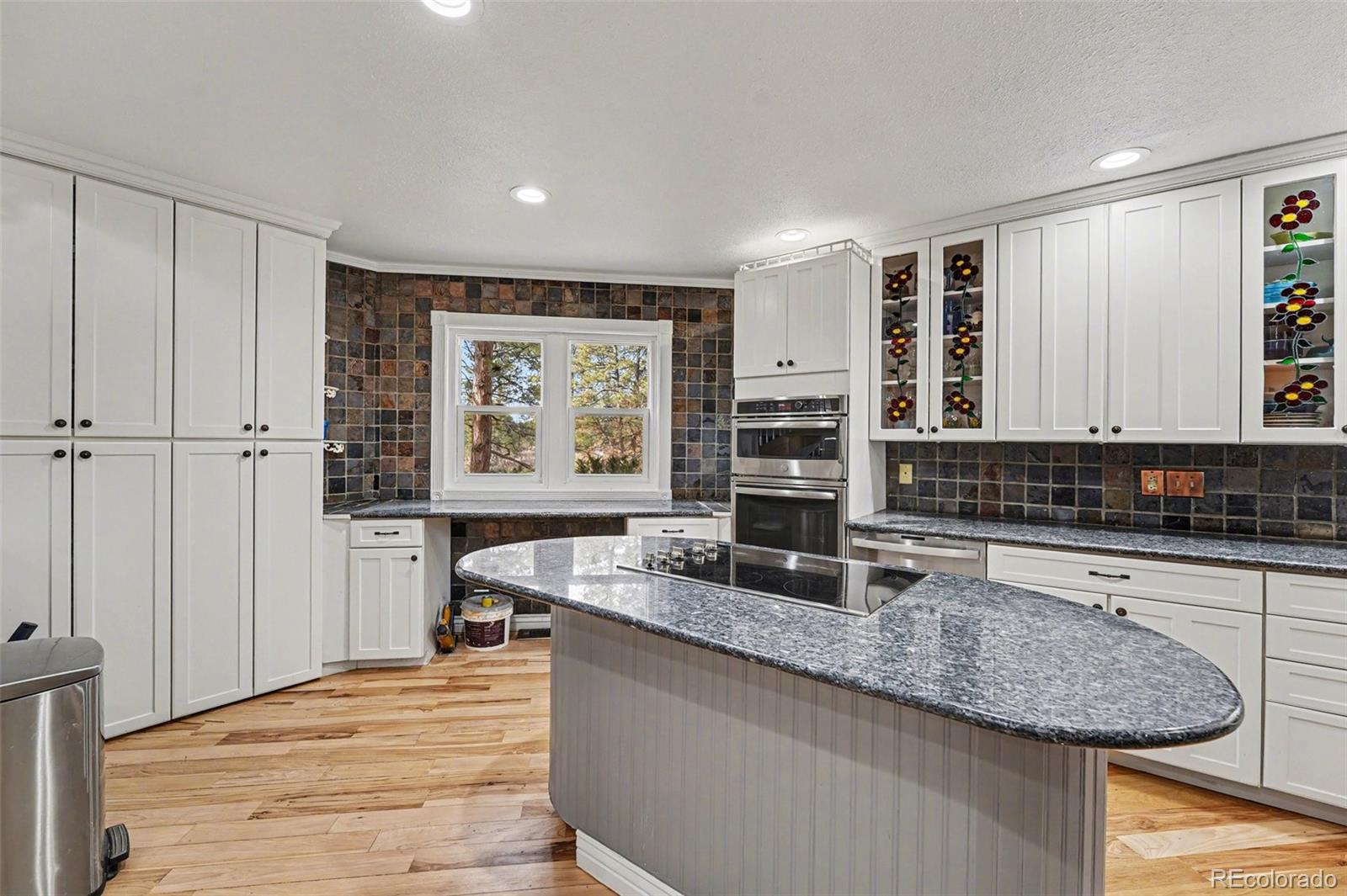 6650 North Village Road Parker, CO 80134 - Photo 7 of 46 a kitchen with stainless steel appliances granite countertop a sink and a wooden cabinets