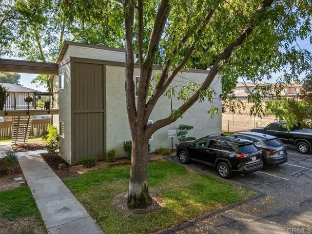 a view of a car parked in back yard of a house