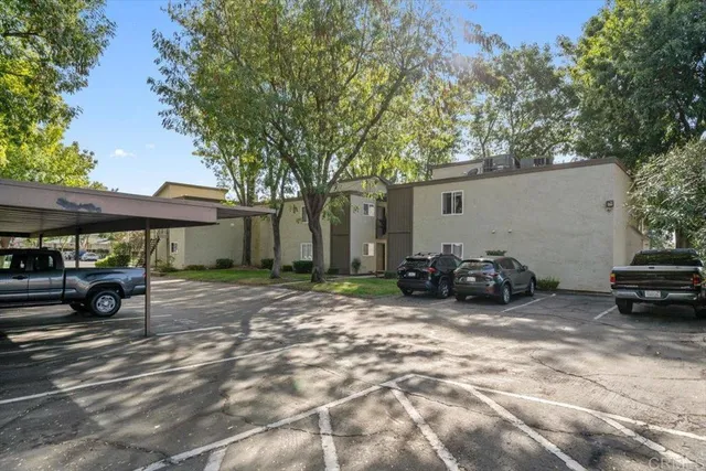 a view of a house with cars parked in front of house