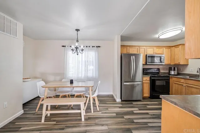 a kitchen with granite countertop counter space a sink appliances and cabinets