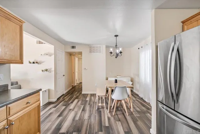 a spacious bathroom with a double vanity sink and a white refrigerator