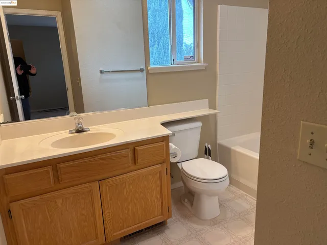 a bathroom with a sink toilet and a mirror