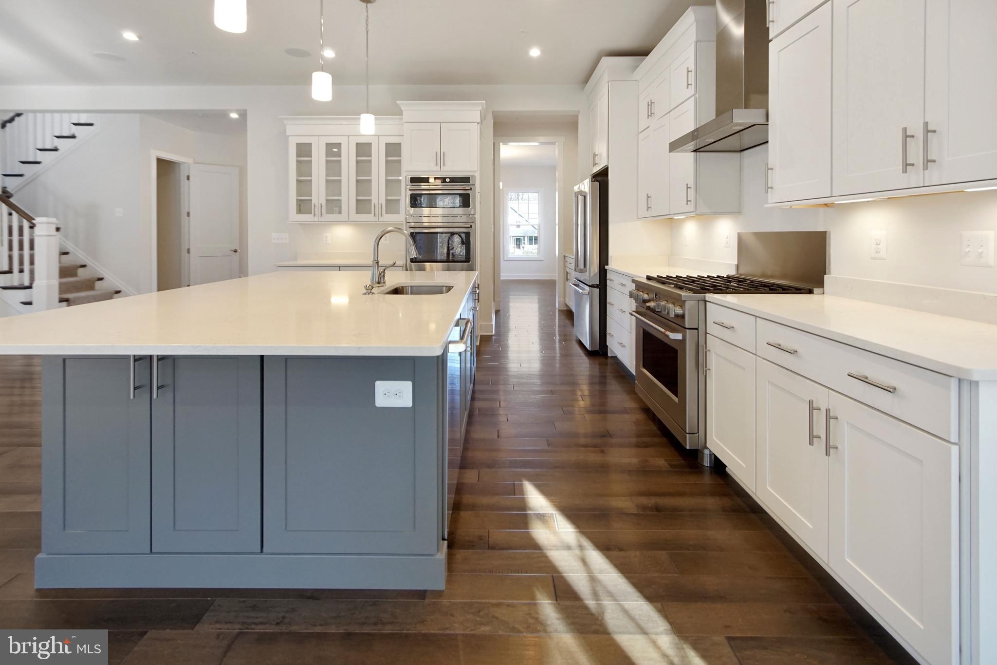 7 Copperleaf Boulevard Hanover, MD 21076 - Photo 15 of 46 a kitchen with stainless steel appliances kitchen island granite countertop a stove a sink and a refrigerator