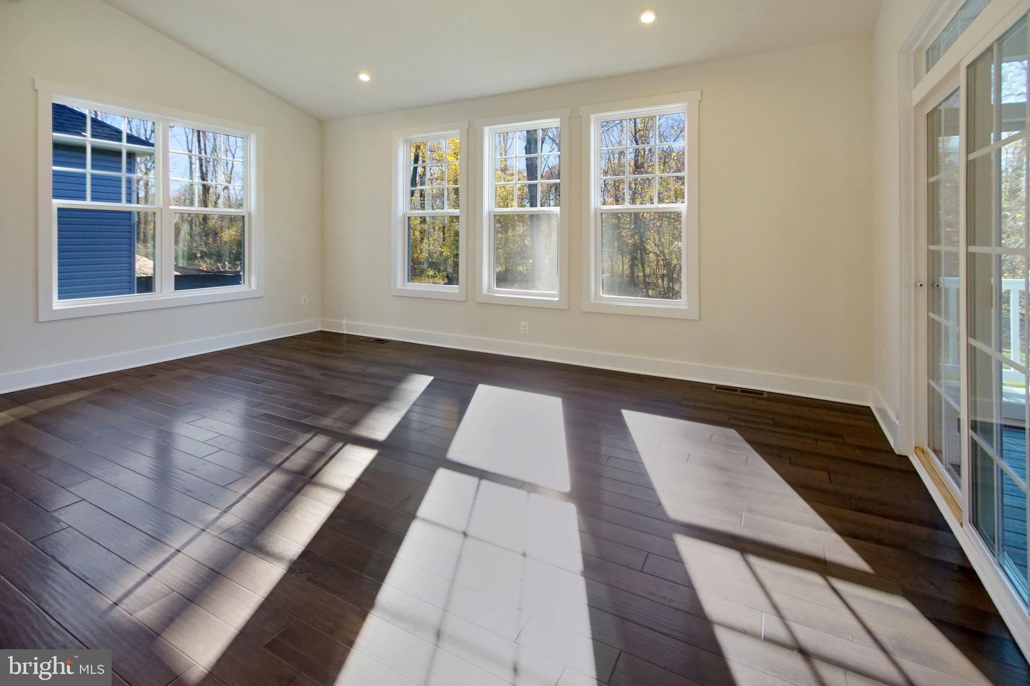 7 Copperleaf Boulevard Hanover, MD 21076 - Photo 22 of 46 an empty room with wooden floor and windows