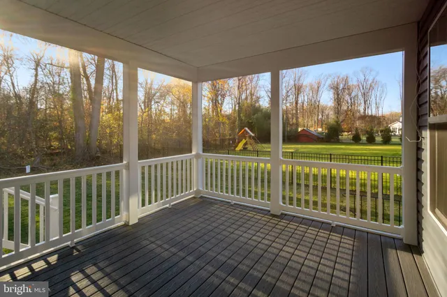 a view of a wooden deck with a yard