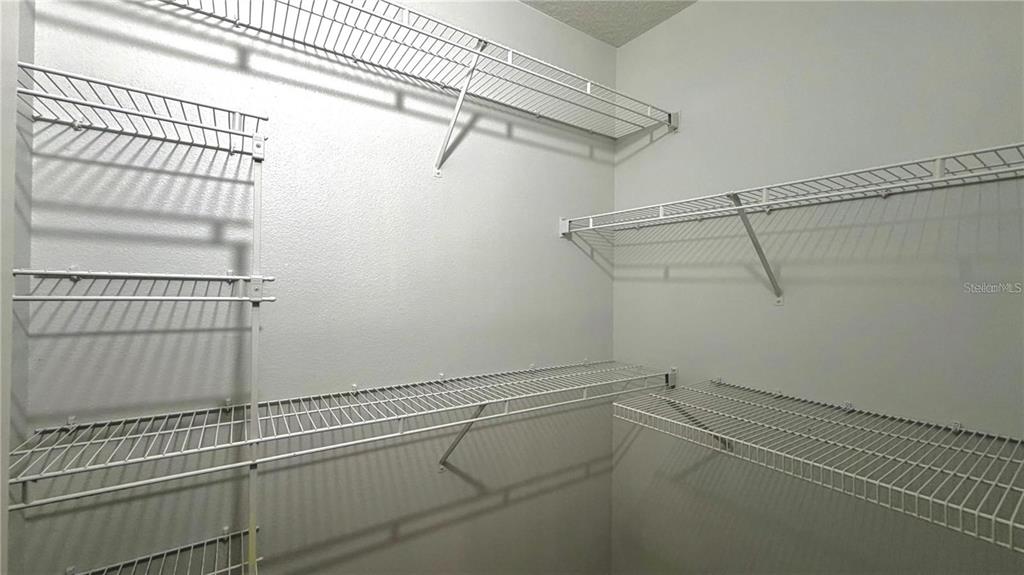 4332 South Kirkman Road, Unit 1012 Orlando, FL 32811 - Photo 7 of 20 a view of a room with racks on the wall