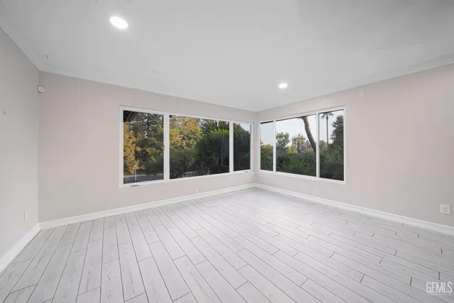 a view of a room with wooden floor and a hallway