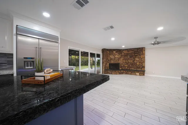 a view of kitchen and kitchen with furniture wooden floor and window