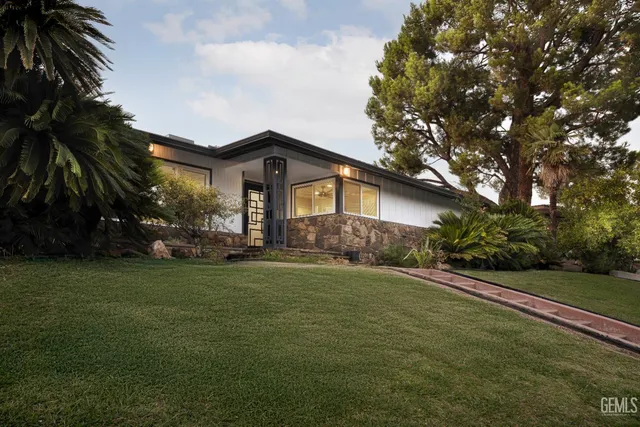 a bathroom with a sink mirror vanity and toilet