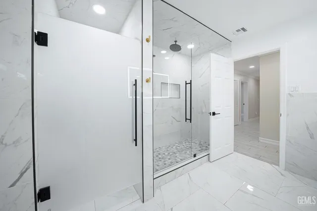 a bathroom with a sink a shower and mirror