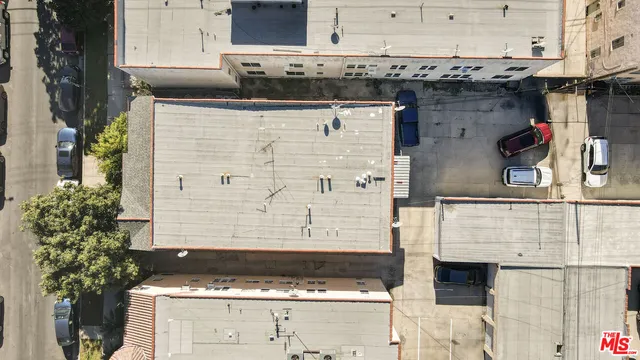 an aerial view of residential houses with city view