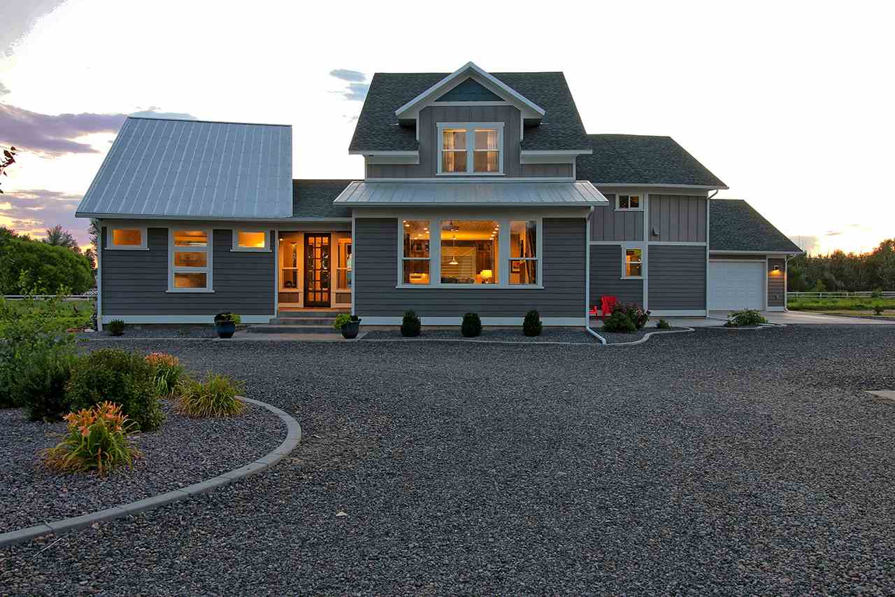 1724 K K 3/4 Road Fruita, CO 81521 - Photo 1 of 42 a front view of a house with garden