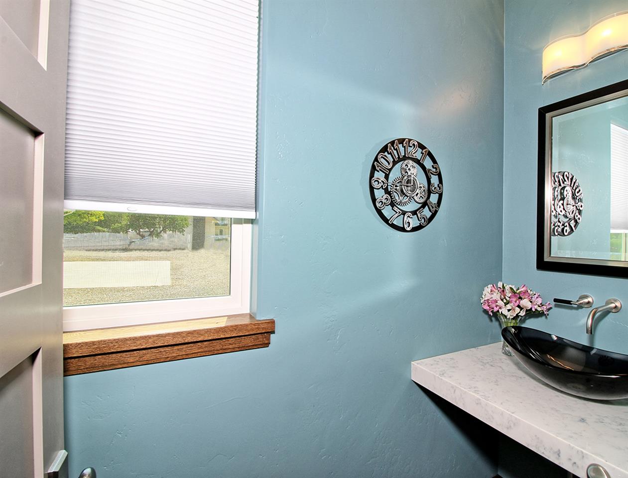 1724 K K 3/4 Road Fruita, CO 81521 - Photo 29 of 42 a table with a vase and flowers on it with a window