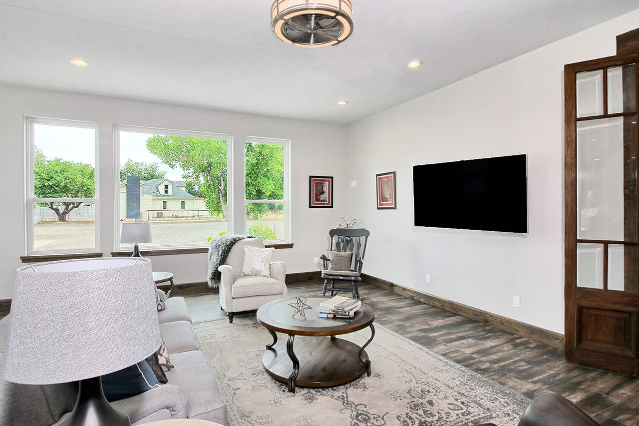 1724 K K 3/4 Road Fruita, CO 81521 - Photo 9 of 42 a living room with furniture and a flat screen tv