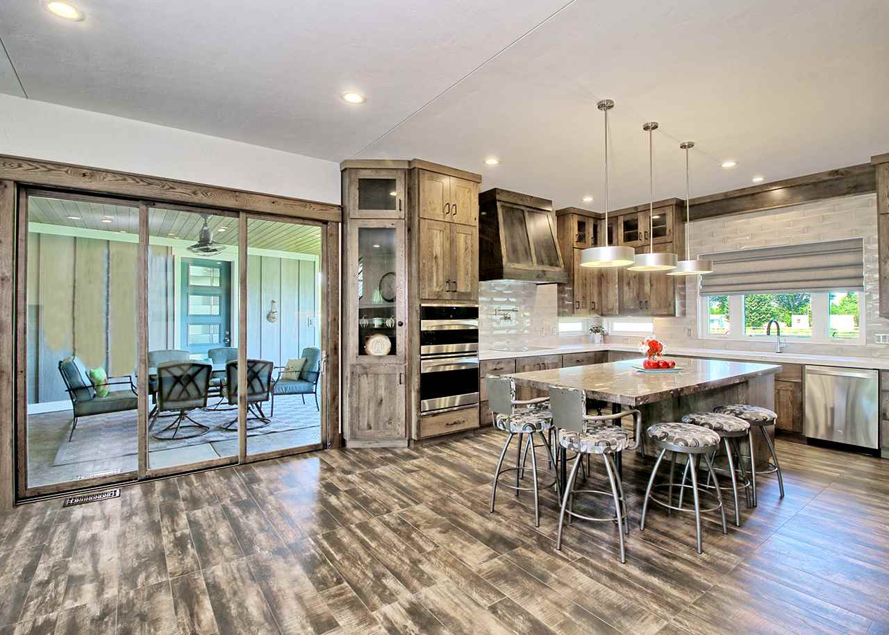 1724 K K 3/4 Road Fruita, CO 81521 - Photo 10 of 42 an open kitchen with granite countertop a stove dining table and chairs
