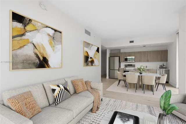 a living room with furniture and a painting on the wall