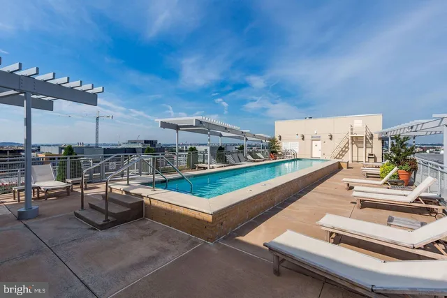 a view of a swimming pool with outdoor seating