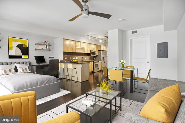 a living room with furniture and kitchen view