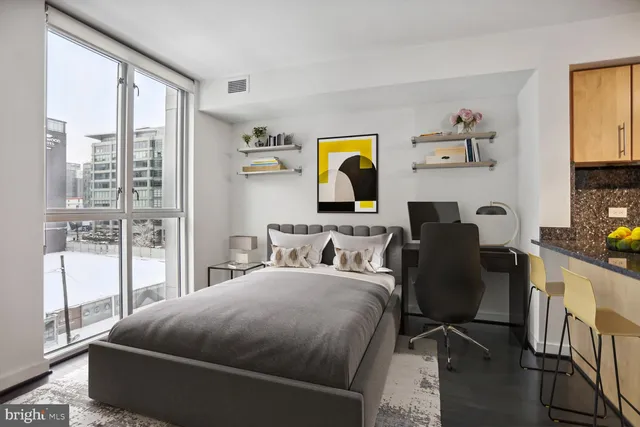 a bedroom with a bed and wooden floor